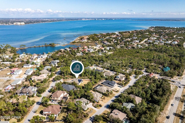 drone / aerial view with a water view and a residential view