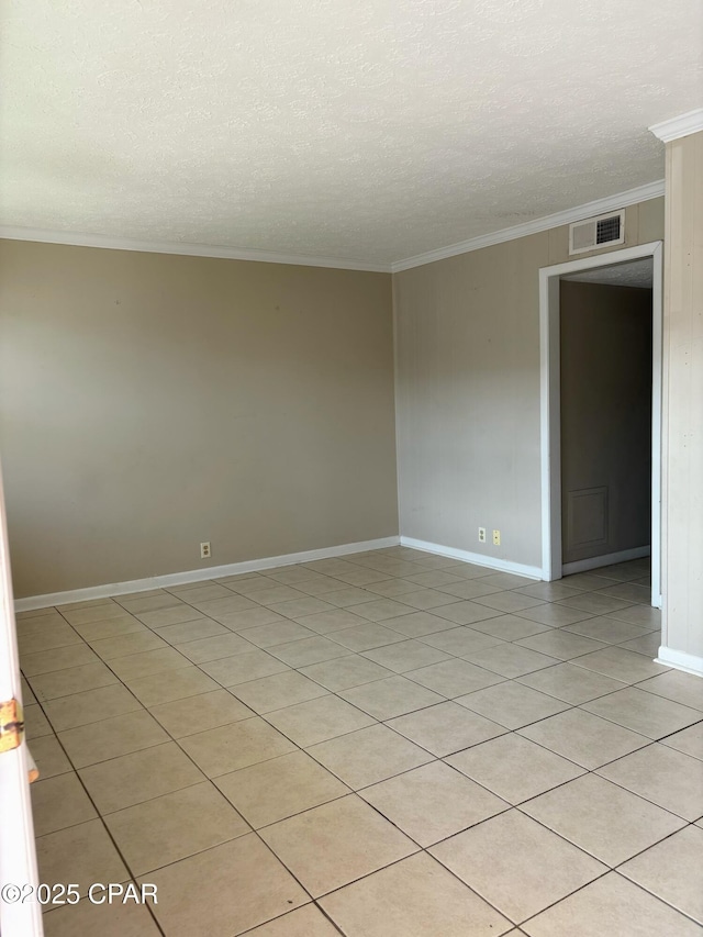 unfurnished room featuring a textured ceiling, ornamental molding, visible vents, and baseboards