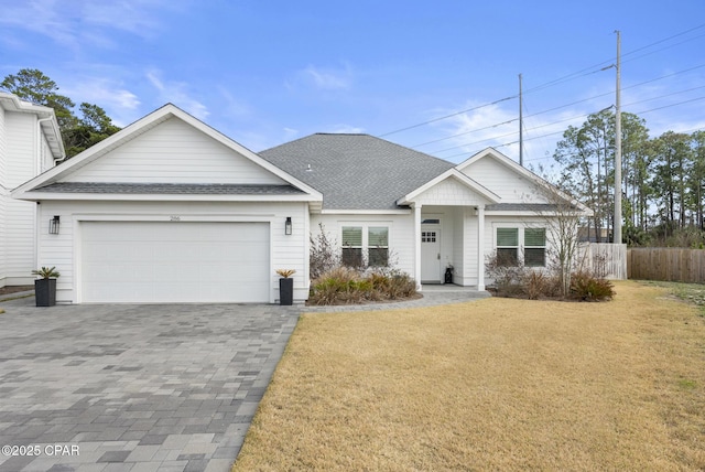 view of front of home featuring a garage and a front yard