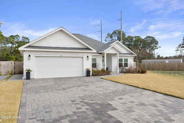 view of front of property featuring a garage and a front lawn