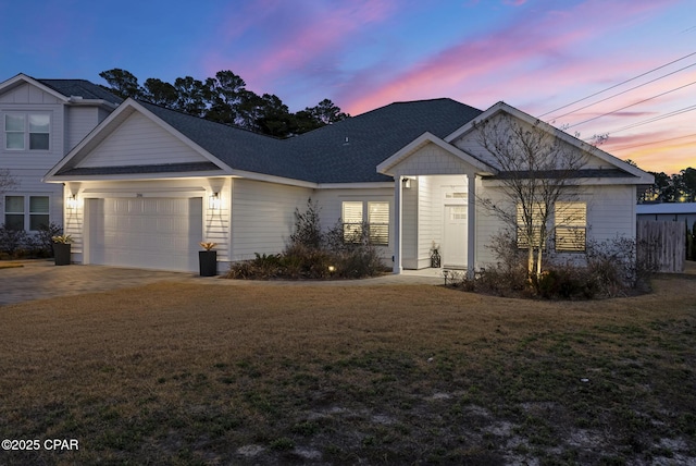 view of front of house featuring a garage and a yard