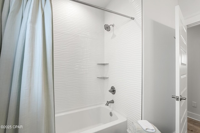 bathroom with hardwood / wood-style flooring and shower / bath combo with shower curtain