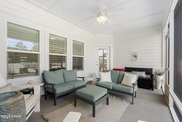 sunroom / solarium featuring ceiling fan