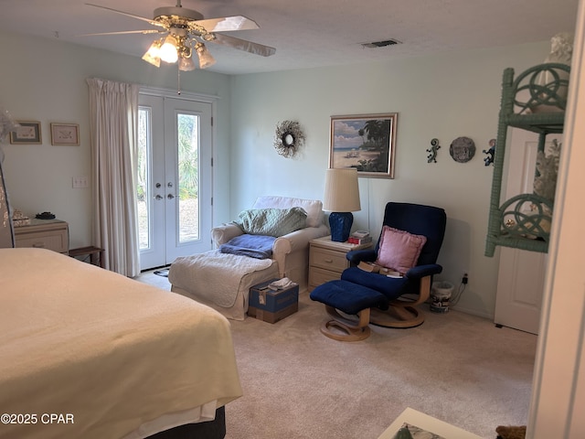 carpeted bedroom with french doors, visible vents, access to exterior, and ceiling fan