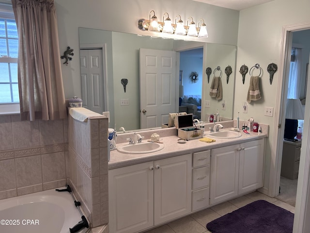 full bathroom with a sink, double vanity, tile patterned flooring, and a tub
