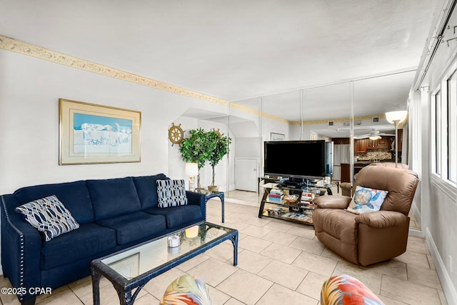 living area with visible vents, baseboards, and light tile patterned floors