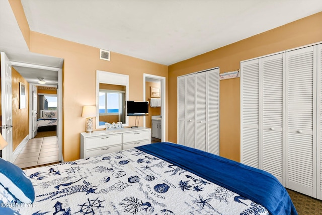 bedroom with multiple closets and visible vents