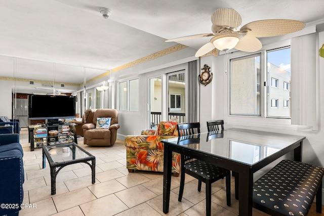 dining room with a healthy amount of sunlight, a ceiling fan, and tile patterned floors