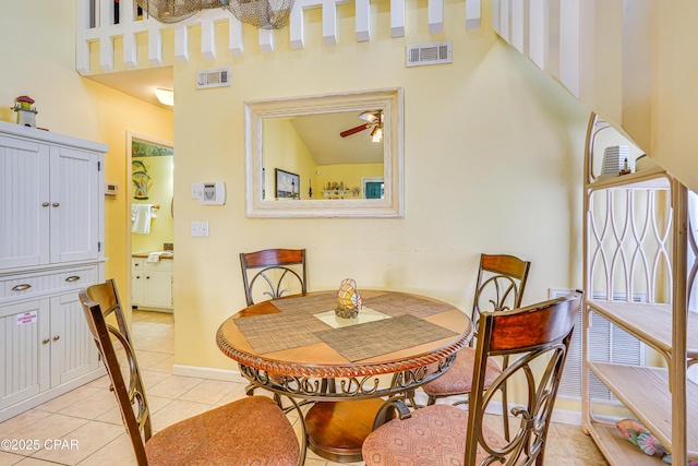 dining room with light tile patterned flooring and a towering ceiling