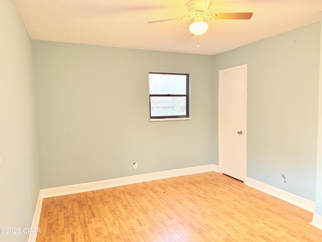 spare room featuring ceiling fan, a textured ceiling, and light wood-type flooring