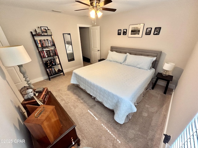 bedroom with baseboards, ceiling fan, visible vents, and light colored carpet