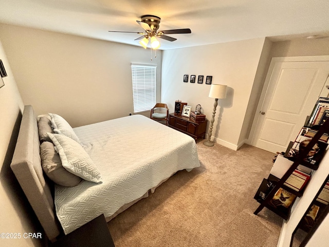 bedroom featuring light carpet, a ceiling fan, and baseboards