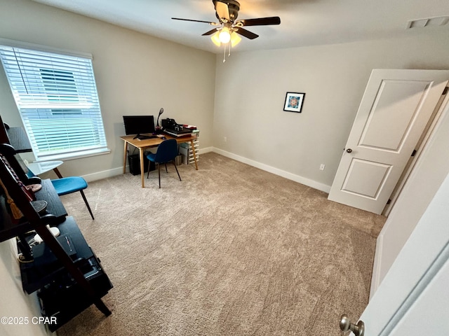 home office featuring a ceiling fan, visible vents, baseboards, and carpet flooring