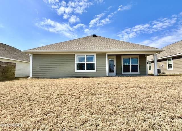 back of property featuring a shingled roof