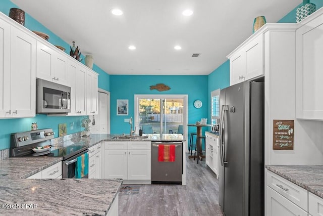 132 Gulf Terrace Ln, Port St Joe, FL 32456 - kitchen with appliances with stainless steel finishes, a sink, a peninsula, recessed lighting, and white cabinets