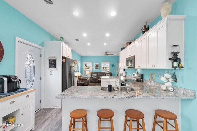 132 Gulf Terrace Ln, Port St Joe, FL 32456 - kitchen with appliances with stainless steel finishes, a sink, open floor plan, a peninsula, and recessed lighting