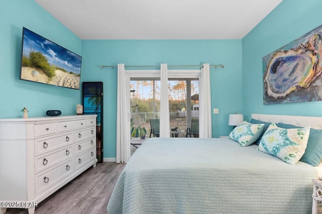 132 Gulf Terrace Ln, Port St Joe, FL 32456 - bedroom with access to exterior, wood finished floors, and baseboards