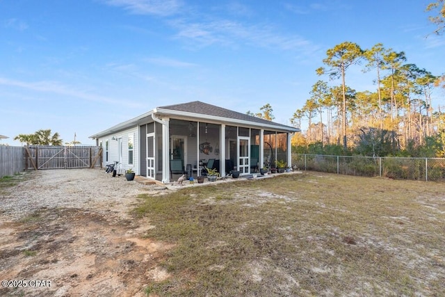 132 Gulf Terrace Ln, Port St Joe, FL 32456 - rear view of house featuring a sunroom, a gate, and a fenced backyard