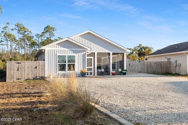 132 Gulf Terrace Ln, Port St Joe, FL 32456 - back of house featuring a sunroom, fence, a gate, and board and batten siding
