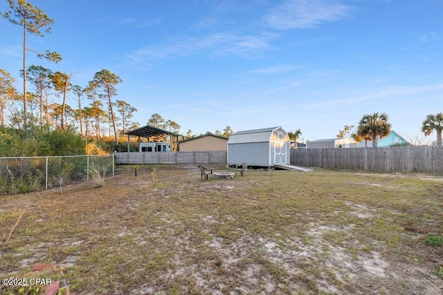 132 Gulf Terrace Ln, Port St Joe, FL 32456 - fenced backyard featuring a detached carport, a storage shed, and an outbuilding
