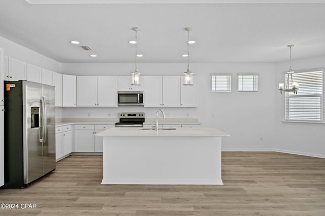kitchen featuring recessed lighting, light countertops, white cabinetry, appliances with stainless steel finishes, and a sink