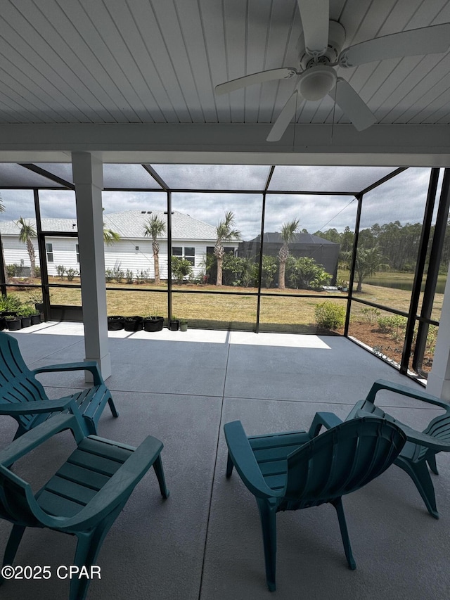 sunroom / solarium with a ceiling fan