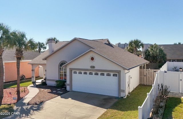 view of front facade featuring an attached garage, fence, concrete driveway, and stucco siding