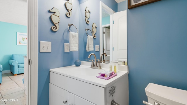 bathroom with vanity, toilet, and tile patterned floors