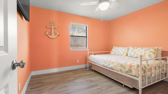 bedroom featuring ceiling fan and wood-type flooring