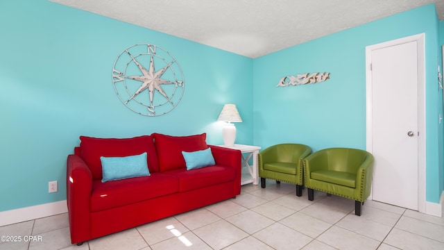 living area with light tile patterned floors and a textured ceiling