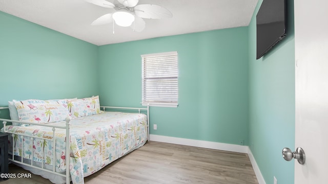 bedroom with ceiling fan and wood-type flooring