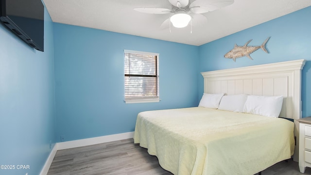 bedroom featuring light hardwood / wood-style flooring and ceiling fan