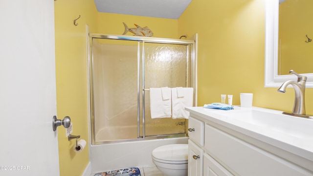 full bathroom with vanity, combined bath / shower with glass door, and toilet