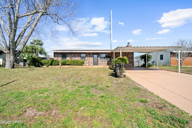 single story home featuring a carport and a front yard