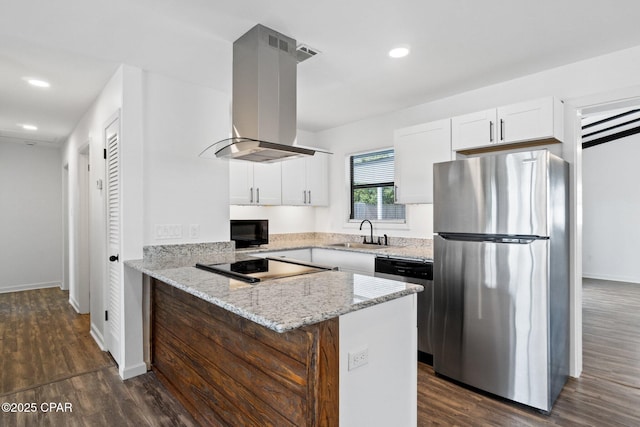 kitchen with white cabinets, black appliances, island exhaust hood, sink, and kitchen peninsula