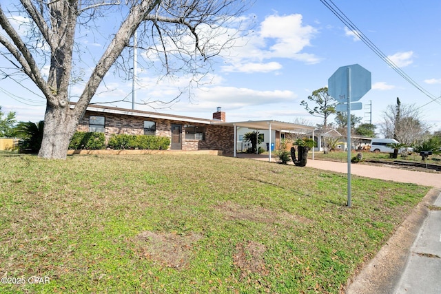 ranch-style house with a front lawn and a carport