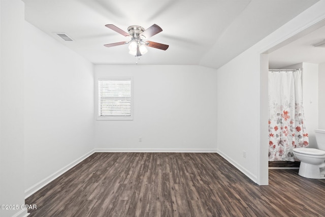 unfurnished room with ceiling fan, lofted ceiling, and dark wood-type flooring