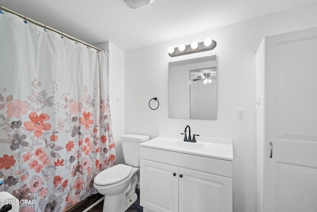 bathroom with toilet, vanity, and walk in shower