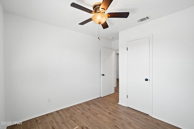 unfurnished bedroom with light wood-type flooring and ceiling fan