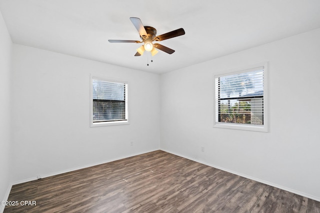 spare room with ceiling fan and dark hardwood / wood-style flooring