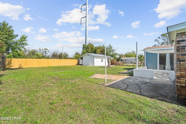 view of yard with a storage shed and a patio area