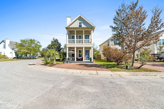 view of front of property featuring a balcony and covered porch