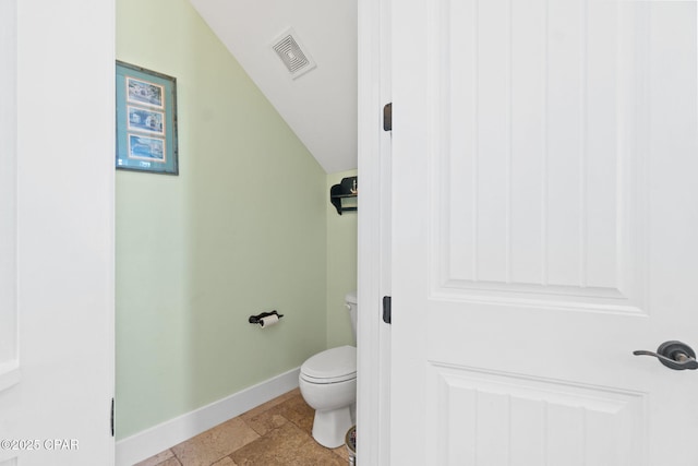 bathroom with visible vents, baseboards, toilet, and lofted ceiling