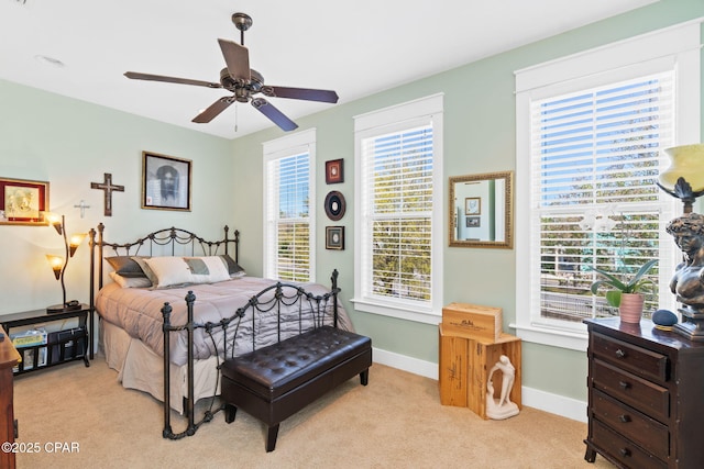 bedroom featuring baseboards, a ceiling fan, and light colored carpet