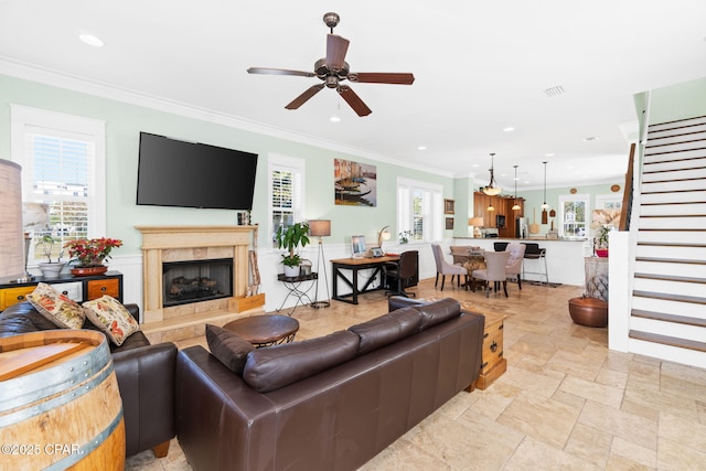 living area featuring ornamental molding, visible vents, stairway, and recessed lighting