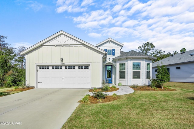 view of front of property with a front yard and a garage