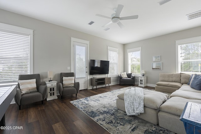 living room featuring plenty of natural light, dark hardwood / wood-style floors, and ceiling fan