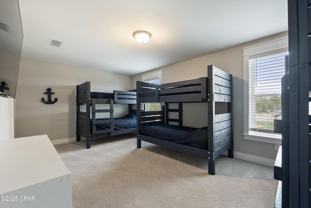 bedroom featuring light colored carpet