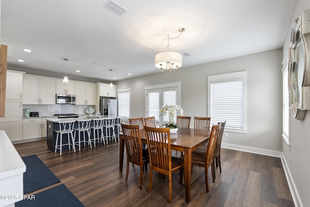 dining space with dark hardwood / wood-style flooring