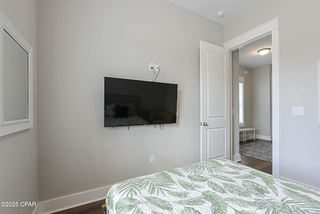 bedroom with dark hardwood / wood-style flooring